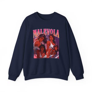 May include: A navy blue sweatshirt with a graphic of four women with red skin and horns. The word "MALEVOLA" is printed in pink and orange above the graphic. The women are wearing white tank tops and red tops.