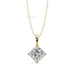 May include: A gold pendant necklace featuring a square-cut diamond. The diamond is set in a gold bezel and hangs from a delicate gold chain. The necklace is displayed against a white background.