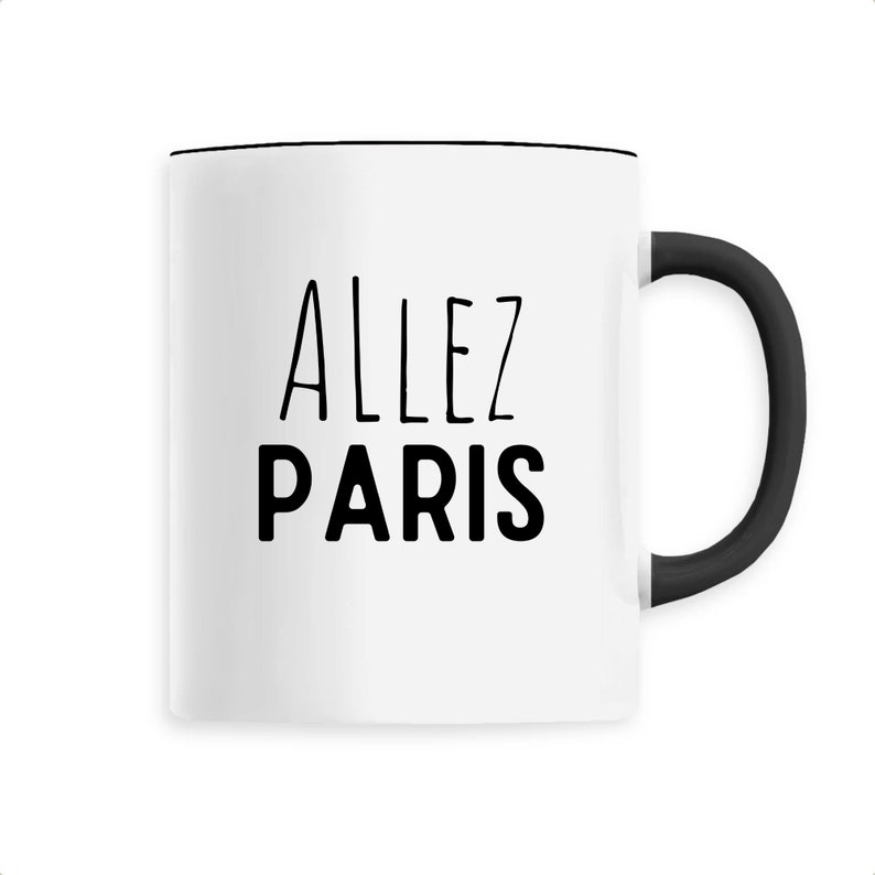 May include: White ceramic mug with a black handle and rim. The mug features the words "ALLEZ PARIS" in black, uppercase letters. The design is simple and modern, suitable for coffee, tea, or other beverages.
