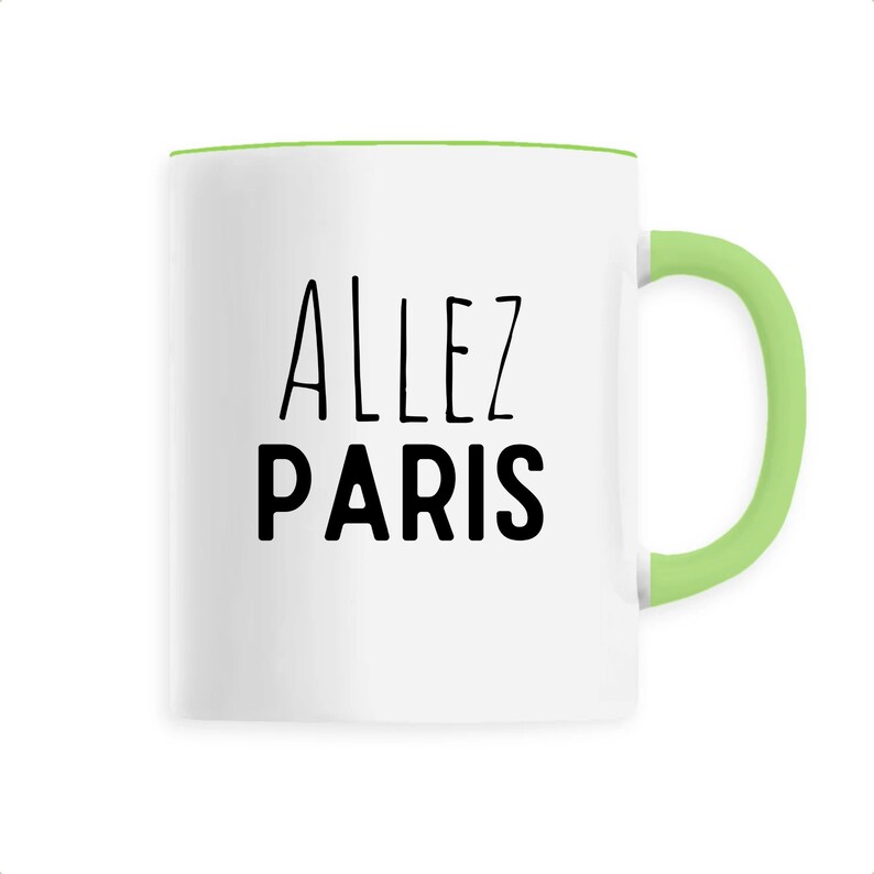 May include: White ceramic mug with a green handle and rim. The mug features the words "ALLEZ PARIS" in black, a phrase associated with Paris, France. The mug is designed for beverages.