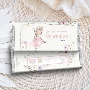 May include: A white chocolate bar wrapper with a floral design and a ballerina illustration. The text on the wrapper says "Thank's for coming to Charlotte's Party".