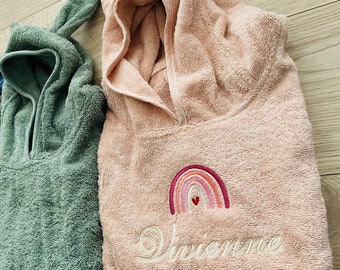 May include: Two hooded towels, one green and one pink. The pink towel has a rainbow and the name "Vivienne" embroidered on it.