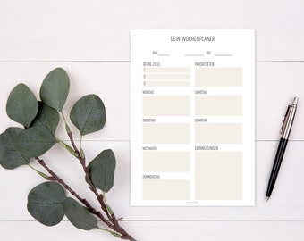May include: A printable weekly planner with sections for goals, priorities, daily tasks, and reminders. The planner is printed on white paper and has a simple, minimalist design.