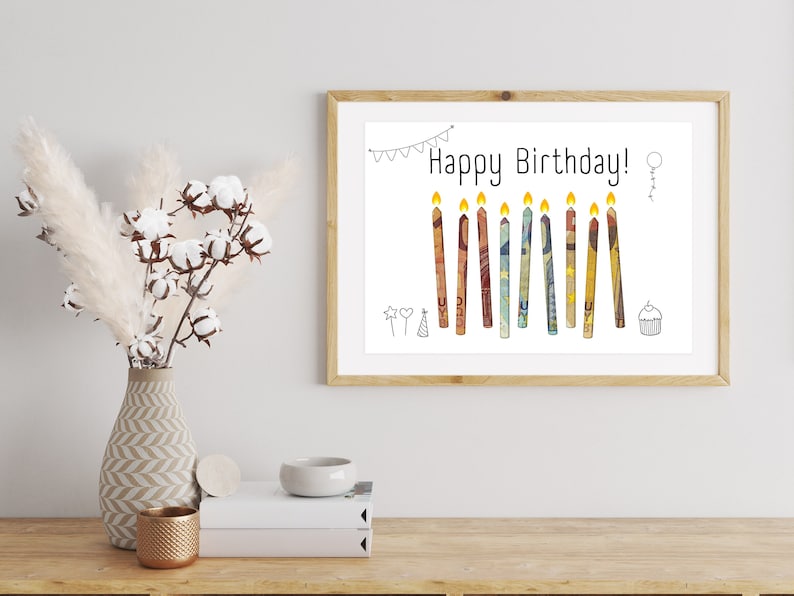 May include: A printable birthday card with the text "Happy Birthday!" and a row of colorful candles made from paper money. The candles are surrounded by simple hand-drawn decorations.