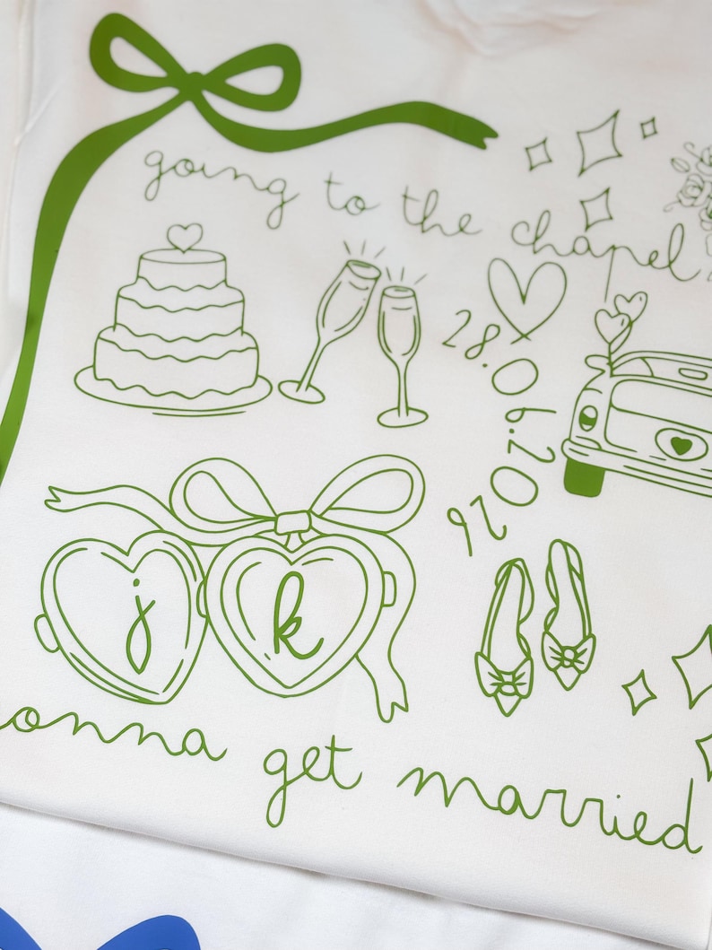 May include: White fabric with green line art illustrations of wedding-themed elements. Includes a cake, champagne glasses, a car, hearts, shoes, and the text "going to the chapel" and "gonna get married".