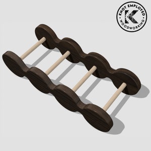 May include: A dark brown wooden wine rack with five bottle slots and four dowel rods. The rack is designed to hold wine bottles horizontally.