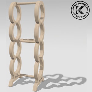 May include: A wooden towel rack with a circular design. The rack has three tiers and a base with four legs. The rack is made of light brown wood.
