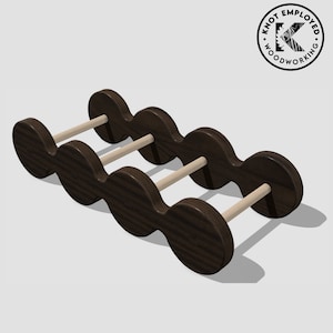May include: A dark brown wooden wine rack with a wavy design and four rows of circular openings. The rack is made of solid wood and has a natural finish.