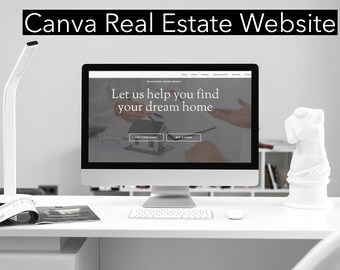 May include: A computer monitor displays a real estate website with the text "Let us help you find your dream home." A white desk holds the monitor, a lamp, a magazine, a mouse, and a white statue. The text "Canva Real Estate Website" is at the top.