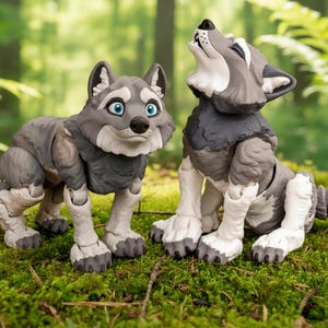 May include: Two articulated wolf figurines. One wolf is standing, the other is howling. The wolves are primarily gray with white and black accents. They have blue eyes and are posed on a bed of green moss, with a blurred forest background.