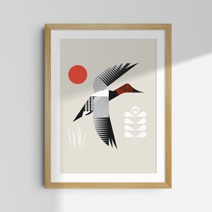 May include: A framed art print featuring a stylized illustration of a flying duck. The artwork uses geometric shapes and a limited color palette of red, black, white, and beige. A red sun and floral elements are also included.