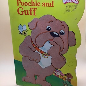 May include: A Golden Fuzzy Shape Book titled "Poochie and Guff" featuring a cartoon bulldog with a red collar. The cover is yellow and green with a bee and other cartoon characters. The book is a vintage children's book.