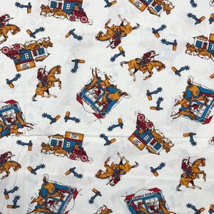May include: White fabric with a repeating pattern of blue and red buildings with the text "General Store" and "Restaurant & Supply". The buildings are surrounded by horses and riders in brown, blue, and red. There are also blue and brown spur designs scattered throughout the fabric.
