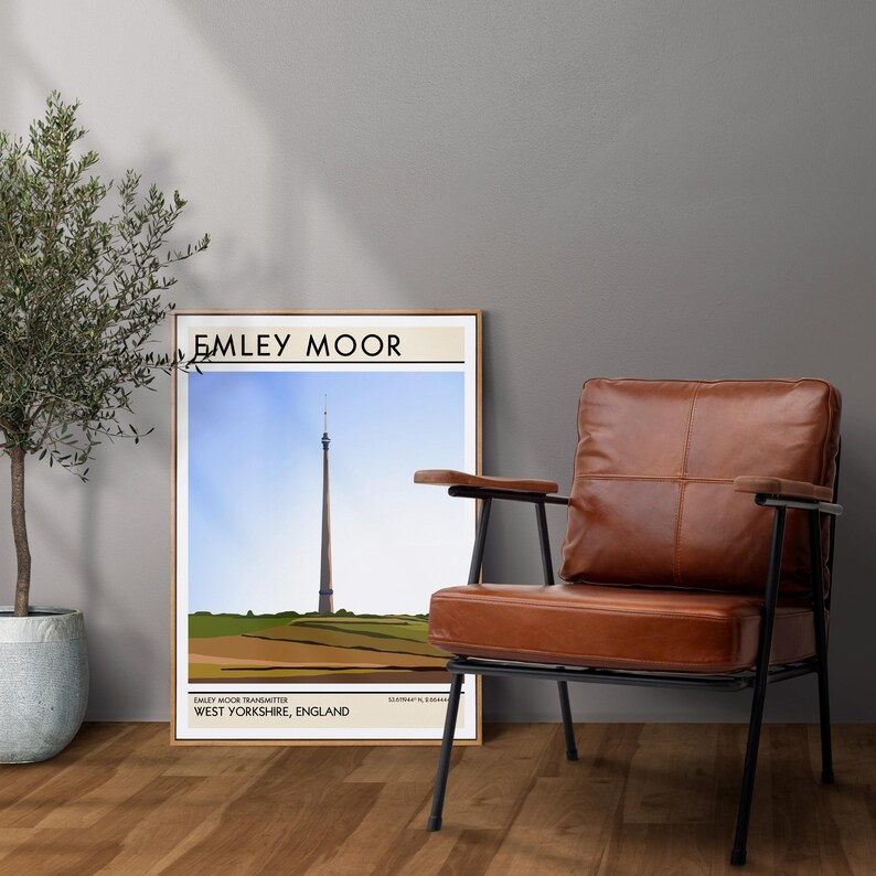 May include: A framed print of a minimalist illustration of a tall tower with the text "Emley Moor" and "Emley Moor Transmitter, West Yorkshire, England" at the bottom.