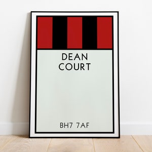 May include: A framed print with a black and white striped design in red and black. The print says "DEAN COURT" and "BH7 7AF".