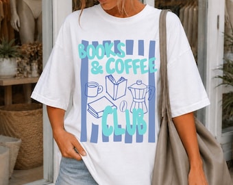 May include: A white short-sleeve t-shirt featuring a graphic print with vertical blue stripes and the text "BOOKS & COFFEE CLUB" in light blue. The design includes line art illustrations of a coffee mug, an open book, a closed book, and a moka pot.