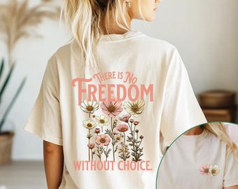 May include: A white t-shirt featuring a floral design and the text "There is No Freedom Without Choice." The shirt is modelled on a person.