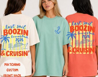 May include: Three t-shirts in cream, light green, and coral. The cream and coral shirts feature a back graphic with a palm tree, cruise ship, and text reading "last sail BOOZIN & CRUISIN' Emma's Bach 2026". The green shirt has a small blue anchor on the front.