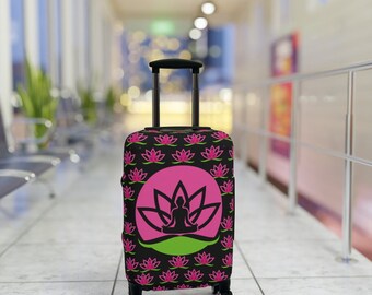 May include: A black suitcase with a pink and green lotus flower design. The design features a silhouette of a person sitting in a lotus position.