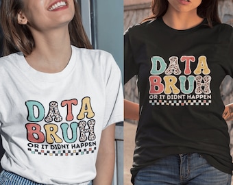 May include: Two white t-shirts with a colorful graphic that says "DATA BRUH OR IT DIDN'T HAPPEN" in a retro font. The graphic has a leopard print pattern.