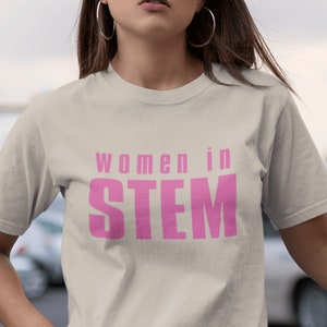 May include: A white t-shirt with the text "women in STEM" printed in pink.