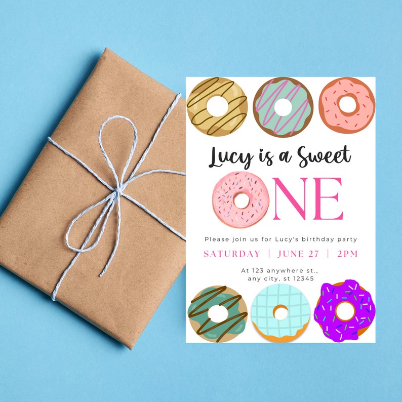 May include: A white birthday party invitation with a donut theme. The invitation says "Lucy is a Sweet One" with a pink donut and the text "Please join us for Lucy's birthday party Saturday June 27 2PM At 123 anywhere st. any city, st 12345".
