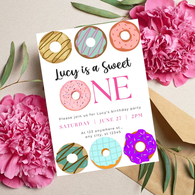 May include: A white invitation card with a pink and black donut theme. The text reads "Lucy is a Sweet ONE". The invitation includes details for a birthday party on Saturday, June 27th at 2 PM.