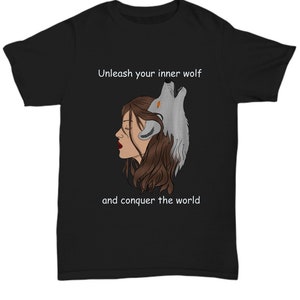 May include: Black t-shirt with a white graphic of a woman with a wolf's head emerging from her hair. The text "Unleash your inner wolf and conquer the world" is printed below the graphic.