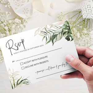 May include: RSVP card with a tropical leaf design. The card has two options: Accept with Pleasure or Decline with Regrets. The text "Kindly respond by September 15th" is printed on the card.