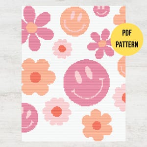 May include: A cross stitch pattern featuring pink and orange flowers and smiley faces on a white background. The pattern is labelled "PDF PATTERN".
