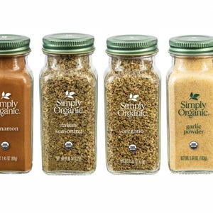 May include: Six glass jars of Simply Organic spices, including spicy curry powder, cinnamon, Italian seasoning, oregano, garlic powder, and cumin. Each jar has a green lid and a label with the spice name.