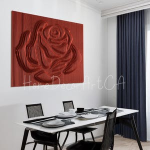 May include: A red 3D wall art sculpture of a rose, with a textured, layered design. The sculpture is mounted on a white wall in a dining room setting.