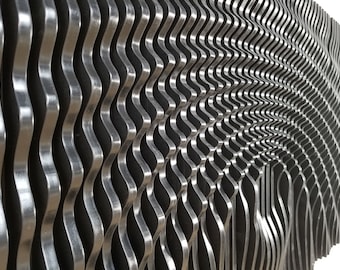 May include: A silver metal wall sculpture with a wavy, geometric pattern. The sculpture is made of many thin, curved metal strips that are arranged in a repeating pattern.