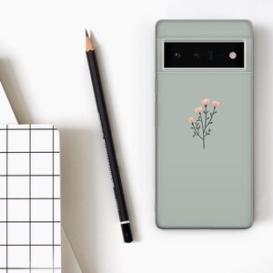 May include: A sage green phone case with a simple floral design featuring pink flowers and green stems.