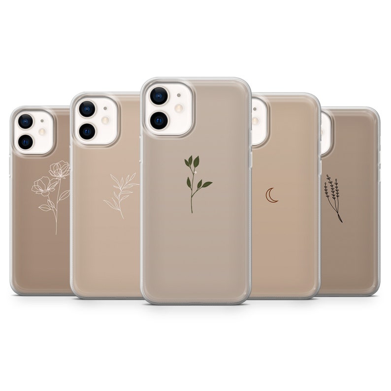 May include: Five clear phone cases with different minimalist designs. The cases are beige with white, green, and brown accents. The designs include a flower, a branch, a leaf, a crescent moon, and a sprig of lavender.