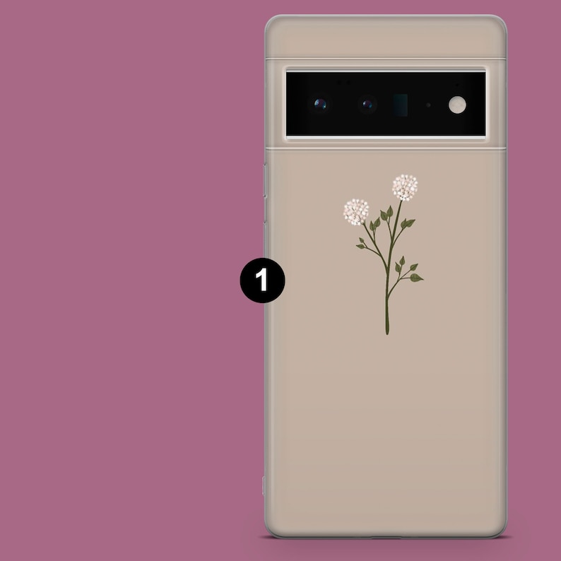 May include: A beige phone case with a floral design. The case has a camera lens cutout and a white flower with green leaves.