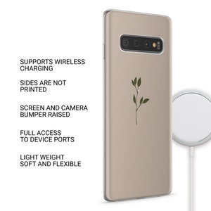 May include: A beige phone case featuring a green twig design. The case is compatible with wireless charging and has a raised bumper to protect the screen and camera.