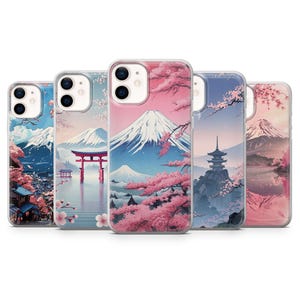 May include: Five phone cases with Japanese landscape designs. Each case features a different scene with Mount Fuji, cherry blossoms, and traditional architecture. The cases have a clear, glossy finish and are designed to fit a smartphone.