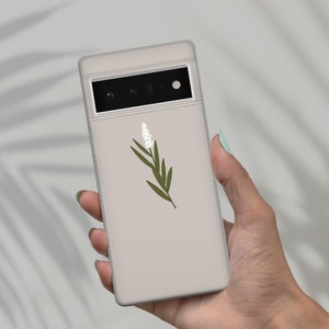 May include: A light gray phone case with a white flower and green leaves design.
