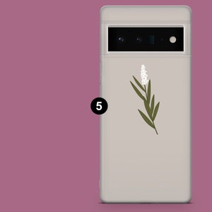 May include: A white phone case with a green floral design and a black number "5" on the side.