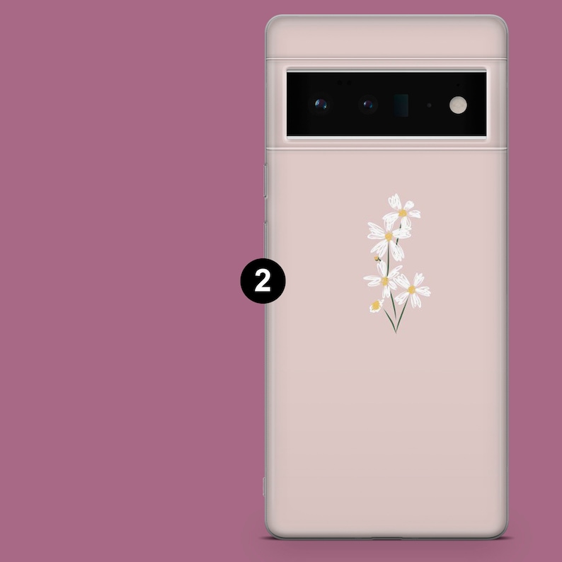 May include: A pink phone case with a white floral design. The case has a raised camera bump with three black lenses.