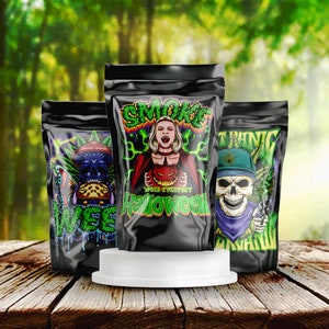 May include: Three black pouches with colorful Halloween-themed graphics. One features a vampire with a pumpkin, another a skull with a cannabis leaf, and the third a skull with a butterfly. The word "SMOKE" is displayed in green.