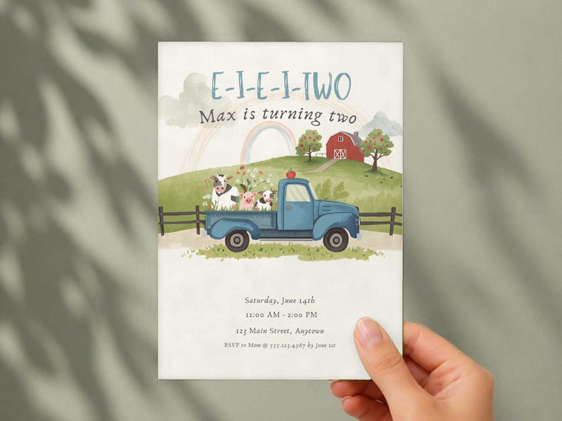 Puede incluir: Una tarjeta de invitaci&oacute;n rectangular con una camioneta azul que transporta una vaca, un cerdo y una oveja. El fondo muestra una granja, un granero rojo y un arco&iacute;ris. Texto: E-I-E-I-TWO, Max is turning two, Saturday, June 14th, 11:00 AM - 2:00 PM, 123 Main Street, Anytown, RSVP to Mom at 555.123.4567 by June 1st.