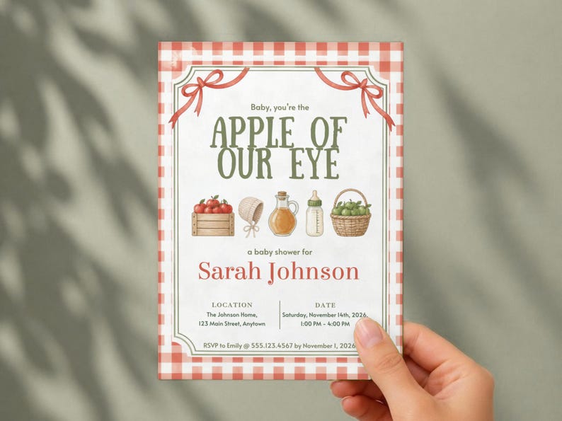 May include: A rectangular baby shower invitation with a red and white gingham border. The text reads: Baby, you're the APPLE OF OUR EYE, a baby shower for Sarah Johnson, with location, date, and RSVP details. Illustrations include apples, a bonnet, a bottle, and a basket.