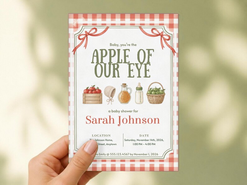 May include: A rectangular baby shower invitation with a red and white gingham border. The text reads: Baby, you're the APPLE OF OUR EYE, a baby shower for Sarah Johnson, location, date, and RSVP details. Illustrations include apples, a bonnet, and a bottle.