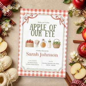 May include: A rectangular baby shower invitation with a red and white gingham border. The text reads: Baby, you're the APPLE OF OUR EYE, a baby shower for Sarah Johnson, location, date, and RSVP details. Illustrations include a crate of apples, a bonnet, a glass bottle, a baby bottle, and a basket of apples.