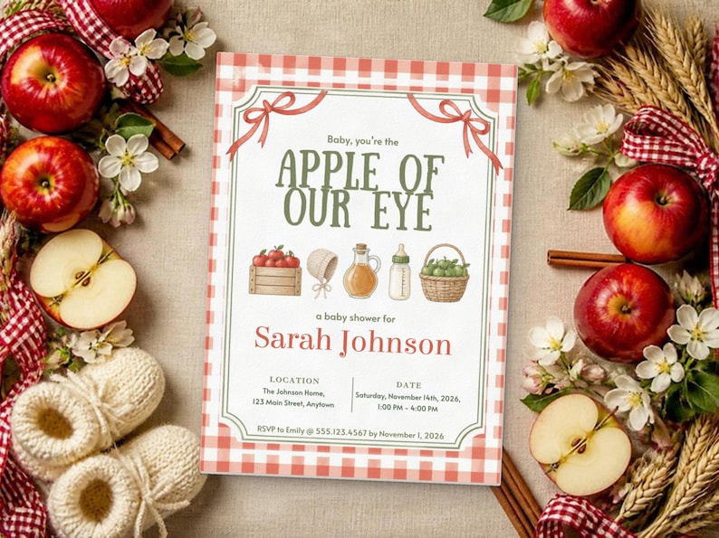 May include: A rectangular baby shower invitation with a red and white gingham border. The text reads: Baby, you're the APPLE OF OUR EYE, a baby shower for Sarah Johnson, location, date, and RSVP details. Illustrations include a crate of apples, a bonnet, a glass bottle, a baby bottle, and a basket of apples.