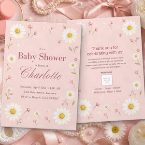 Puede incluir: Dos tarjetas de invitaci&oacute;n rectangulares para baby shower en rosa suave con ilustraciones de margaritas blancas. La tarjeta de la izquierda dice It's a Baby Shower in honor of Charlotte con los detalles del evento.