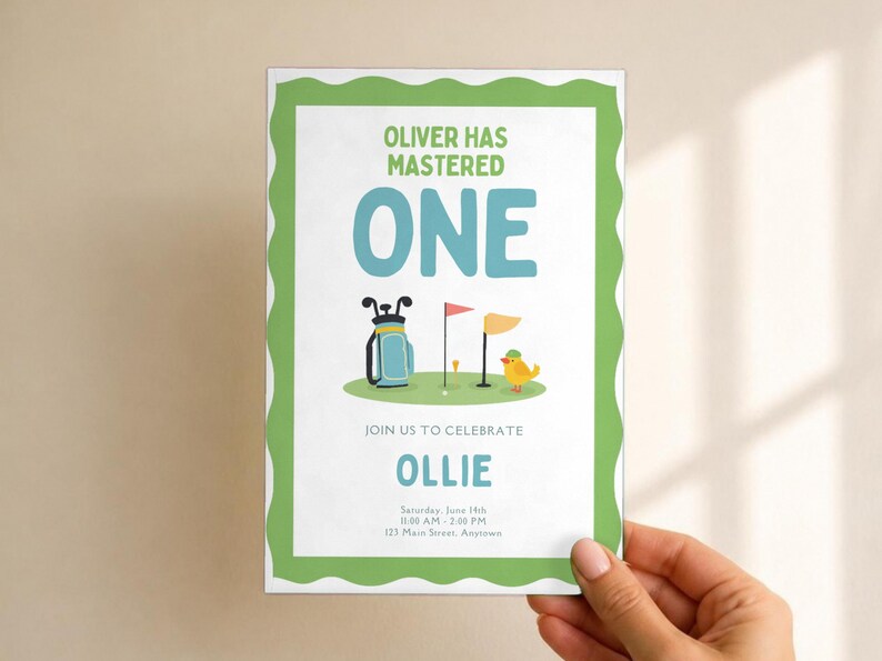 May include: A rectangular invitation card with a green scalloped border. The text reads: OLIVER HAS MASTERED ONE, JOIN US TO CELEBRATE OLLIE, Saturday, June 14th, 11:00 AM - 2:00 PM, 123 Main Street, Anytown. Features a golf bag, flag, and bird.