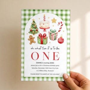 May include: A rectangular invitation card with a green and white gingham border. The center features watercolor illustrations of a Christmas tree, cake, gingerbread man, gifts, candy cane, and ornament, with the text oh what fun it is to be ONE.